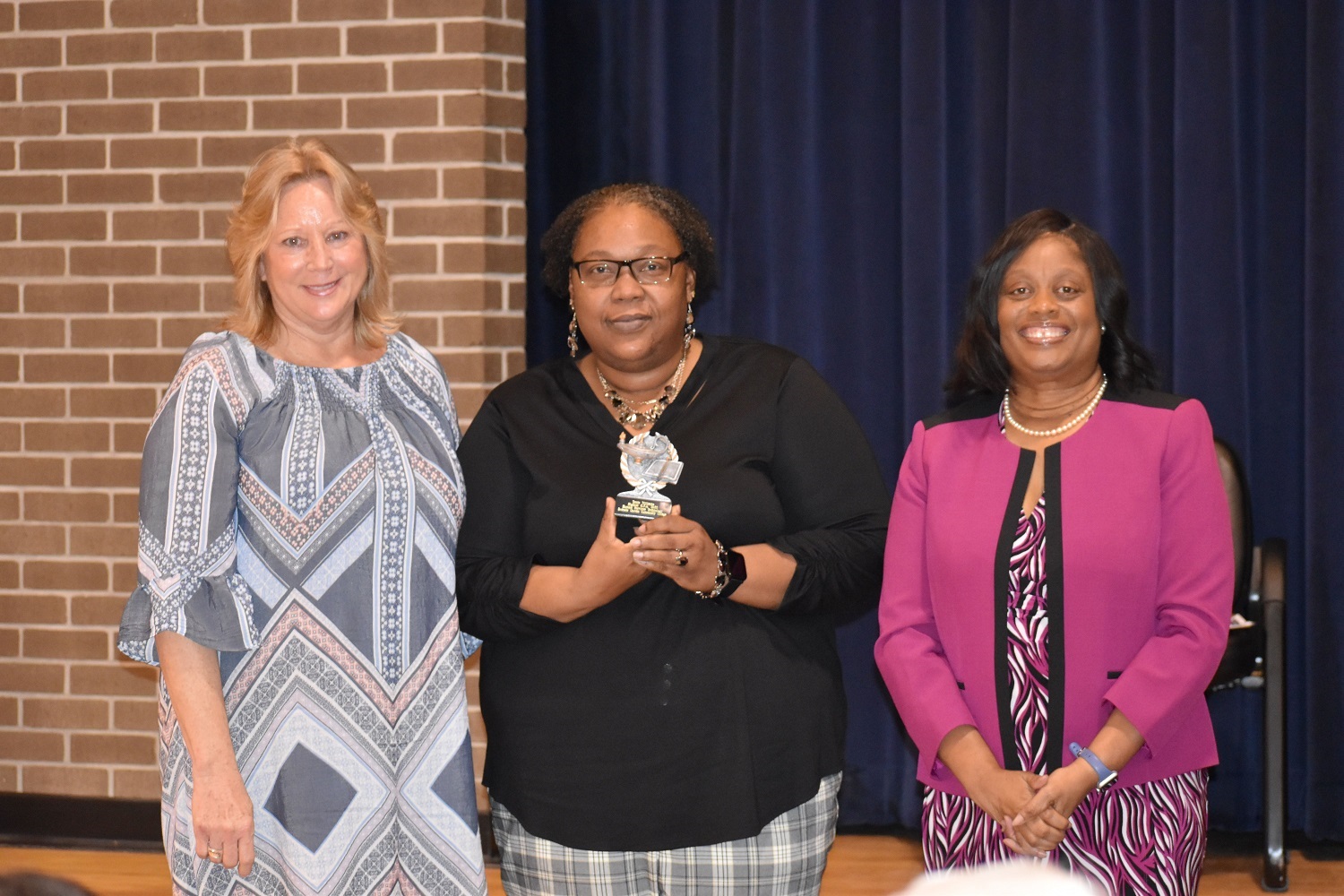 Kimberly Harrell, Associate Dean of Instruction (left), presents academic excellence award to Terrie Williams, along with President Williams.